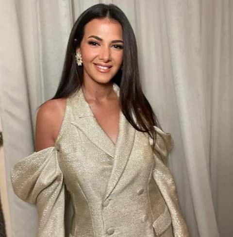 Champagne satin structured-bow look — premiere makeup by Aya Abdelhamid